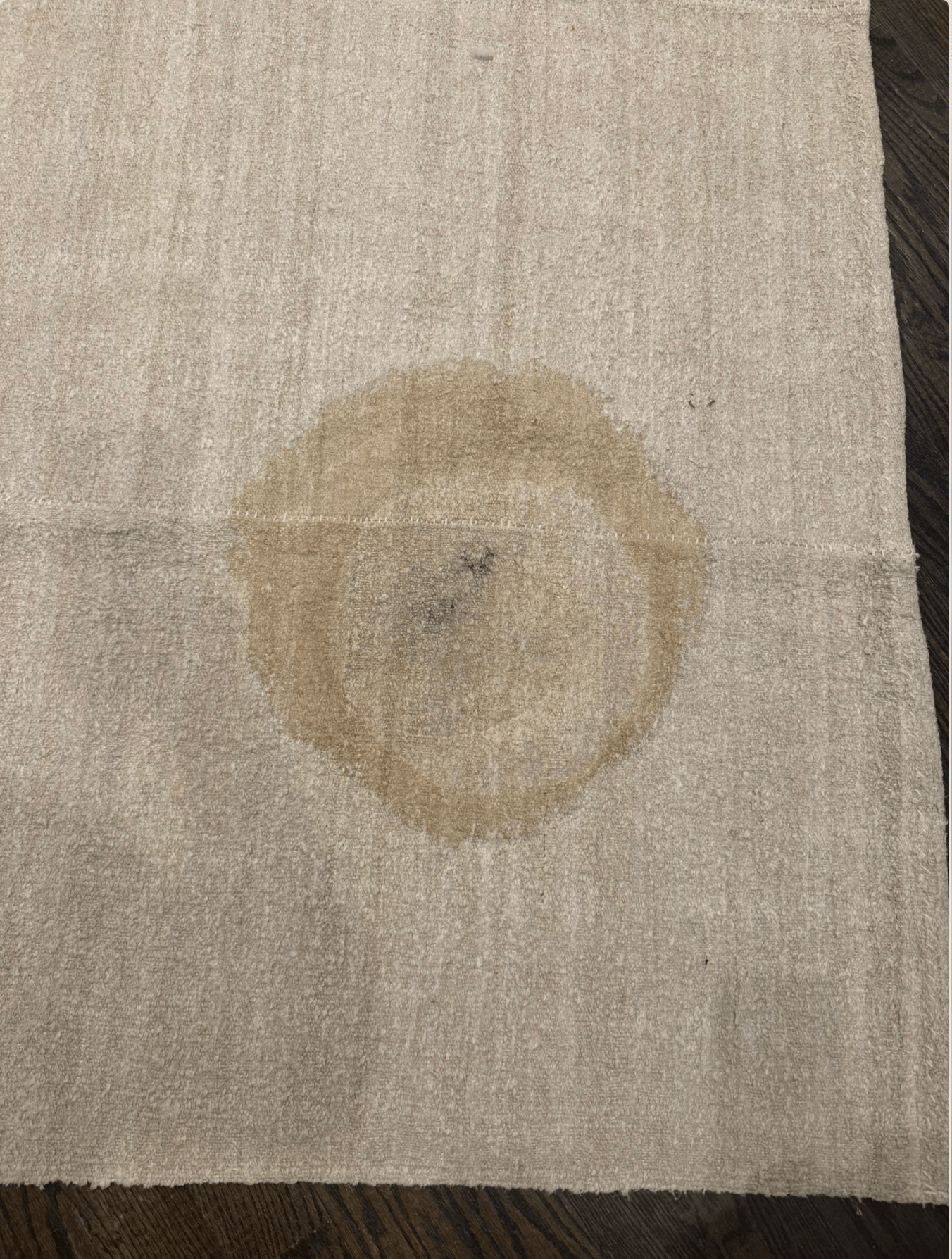 A rug with a drink stain on it 